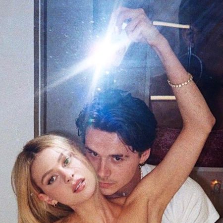Brooklyn Beckham and Nicola Peltz pose for a photo.